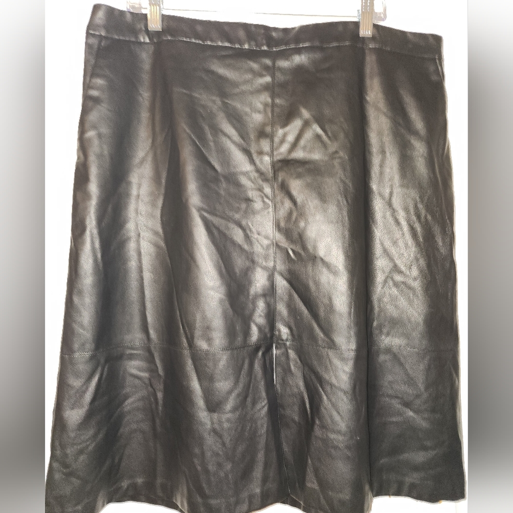 Faux leather knee length skirt with a split 1/3 down by the knees.